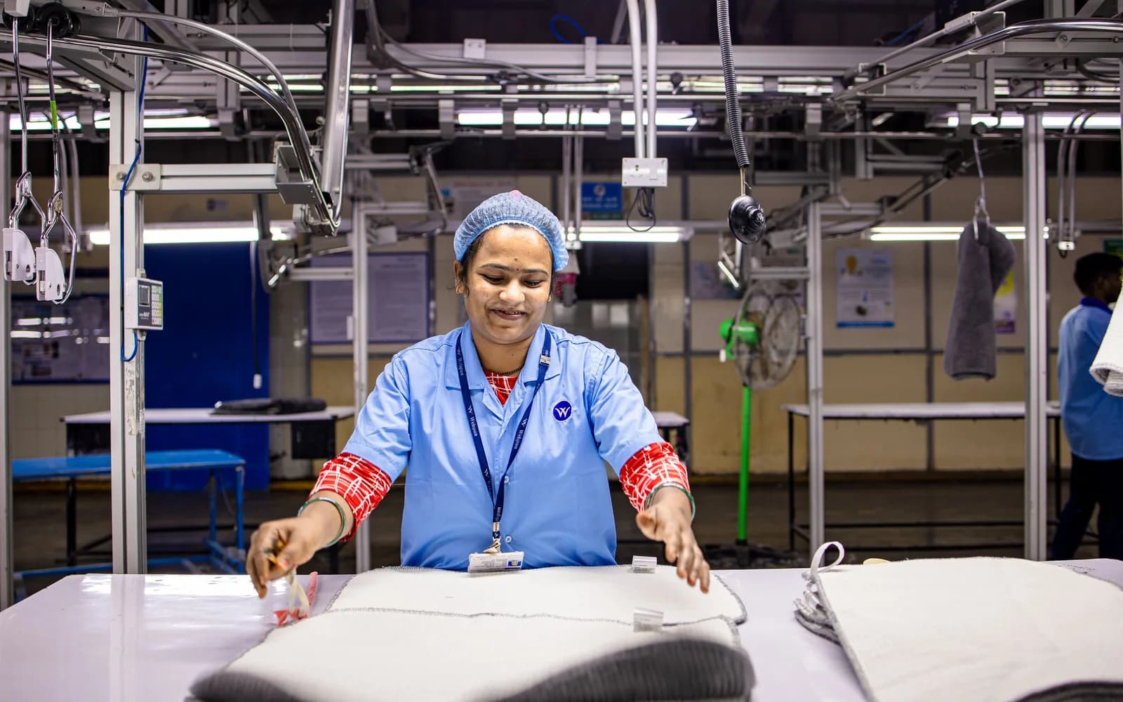 Textile operator working on fabric in a garment manufacturing facility